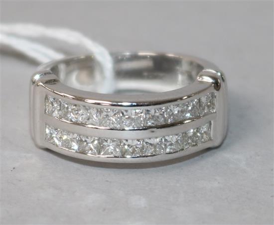 A modern 18ct white gold and twin row channel set diamond ring, size M.